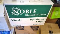 Box labeled 'Noble Disposable Gloves', vinyl, powdered, large, 10 packs of 100 count each.