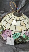 Top angled view of the stained glass pendant light showing the cream-colored and rose floral stained glass details.