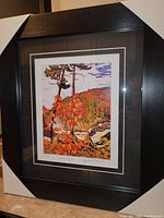 Framed art print showing the entire piece with black modern frame and white matting with black inner border.