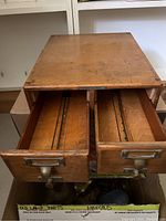Top view showing the oak wood surface and two open drawers with wooden compartments inside, including metal rails.