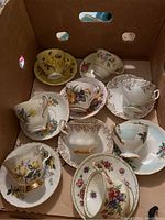 Box of 14 assorted vintage teacups with matching saucers in floral and gold trimmed patterns