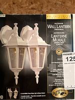 Photo of the product box showing the twin pack of white finish outdoor wall lanterns. Box details include brand Hampton Bay, product description, and some product specs.