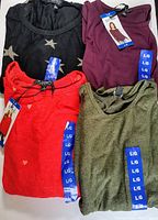 Photo showing all four folded long sleeve knit tops in different colors, each with size L tags attached.
