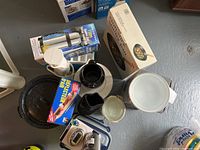 Wide view of cookware lot showing double boiler pots, vacuum flask, immersion blender and more