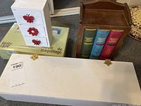 Dressing table lot showing vanity lighted mirror box, floral drawer organizer, and bookshelf box with book design