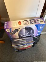 Photo showing massage cushion box in purple and white packaging and one comfort blanket box below it.