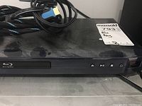 Front view of LG BD555C Blu-ray player showing disc tray and front controls with a MaxSold tag on top.