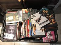 Photo of a bin filled with assorted DVDs showing various titles including The Judge, Donkey Punch, and Che.