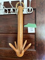 Full front view of the polished wooden sauna coat tree hanger showing six branches and braided loop at top with hanging tags.