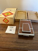 Closed camera on wooden surface with box and foam inserts behind