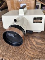 Front view showing projector lens and brand label (Suitte Model 3030)