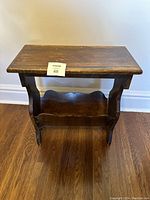 Full view of the vintage small wooden table showing top, sides, and lower rack.
