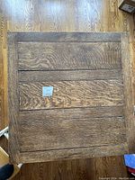 Top view of solid oak table surface showing rectangular plank design and natural wood grain with medium-dark finish.