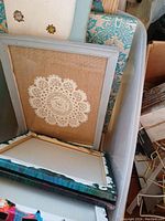 Stacked decorative boxes with framed fabric or lace inserts