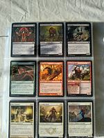 Front view of individual Magic The Gathering cards in sleeves, showing various card titles and artwork.