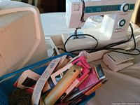 Photo of white Brother LM-5300 vintage sewing machine with power cord and foot pedal, showing the machine's extension table and control dials.