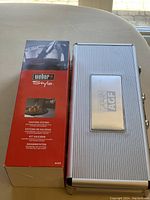 Photo showing Weber Style Saucing System box (model 6433) and silver metal carrying case with AGF branding