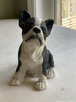Front-side view of black and white French Bulldog dog figurine showing detailed face, ears, and seated posture.