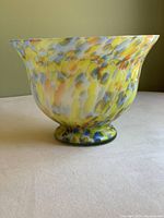 Front view of the large Murano style glass bowl showing colorful confetti pattern in yellow, orange, blue, white, and brown.