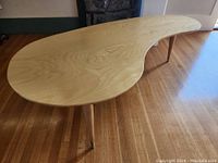 Angled front view showing the curved top surface and all three legs