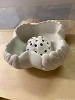 Van Briggle ceramic white floral bowl with scalloped edges and bead trim, with ceramic flower frog positioned inside
