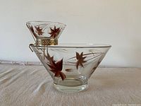 Side view showing large glass chip bowl with hanging smaller dip bowl and attached gold metal holder.