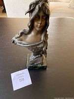 Front view of bronze female bust on marble base showing facial details, flowing hair, and inscribed title "Bohemienne"