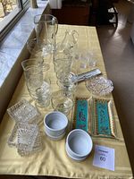 Full view of all items on a table including pitchers, wine cups, fruit bowls, ramekins, candy dishes, and decorative trays.