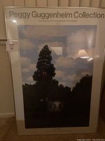 Full view of framed Peggy Guggenheim Collection print showing the full artwork with tree, building, and cloudy sky, and framing details