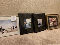 Photo of all four art prints arranged on the floor against a wall, showing frames and sizes.