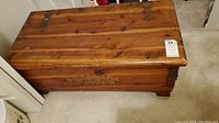 Closed top view of vintage Lane cedar chest showing wooden finish and metal hinges