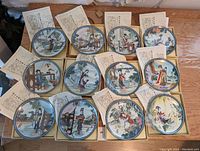 Twelve plates laid out in boxes, each with its corresponding certificate insert