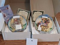 Top view of the two 3D music plates in their original boxes with Certificates of Authenticity and informational pamphlet for one plate