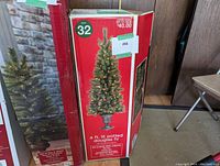 Box of a 4 ft. lit potted Douglas Fir Christmas tree showing tree image and details.