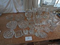 Full arrangement of 26 cut crystal pieces on wood surface