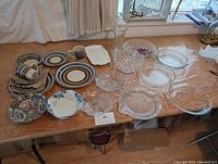 Full table photo showing all dishware including bone china plates, Pyrex pie plates, and various glass serving dishes.
