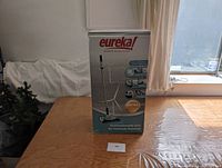 Photo of boxed Eureka Enviro Steamer floor cleaner, showing overall packaging with product image and branding.