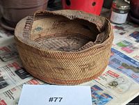 Front angled view of circular woven basket showing the outer detailed weave and rim construction.