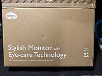 Original cardboard box of BenQ monitor with branding and model GW2283, highlighting its Eye-care Technology and 22-inch size.