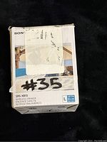 Front and side of the original box with model and key features visible.