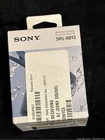 Front view of the Sony SRS-XB13 wireless speaker box showing model and brand details.