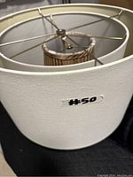 Large white fabric lamp shade showing texture and metal frame inside