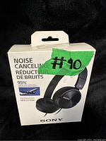 Front of the retail box showing the Sony MDR-ZX110NC noise canceling headphones, with a green label #10 and noise reduction specification of 95%.