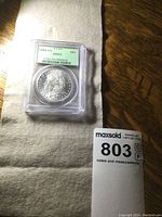 Morgan dollar in PCGS slab showing obverse and grading label