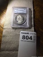 Obverse view of slabbed coin showing 1885-CC Morgan dollar graded MS64 DMPL