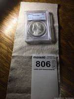 Coin obverse view in PCGS slab with lot tag partially visible.