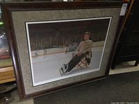 Full view of the large framed signed Bobby Orr print lying on floor showing overall frame and print.