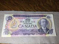 Front side of 1971 Canadian $10 bill showing full bill layout, portrait on right, color scheme, serial numbers and signatures.