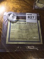 Coin and certificate showing specifications and authenticity from Cook Islands.