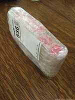 Five tubes of coins wrapped in bubble wrap showing sealed packaging.